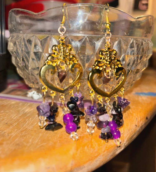 Custom purple earrings flatlay showing design detail